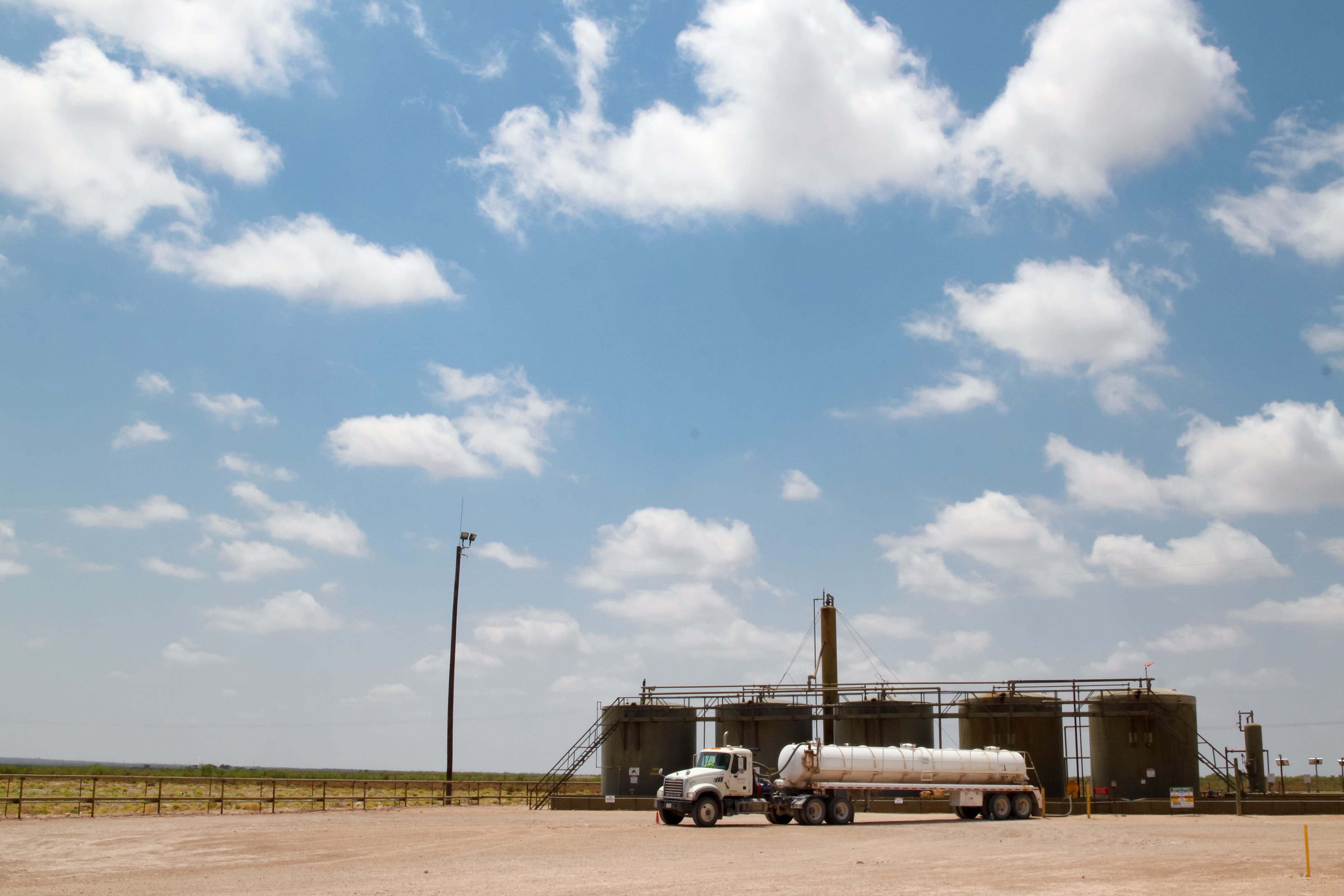 A truck stops at a site with four wells in Hobbs, N.M. (Robin Zielinski for the Center for Public Integrity)