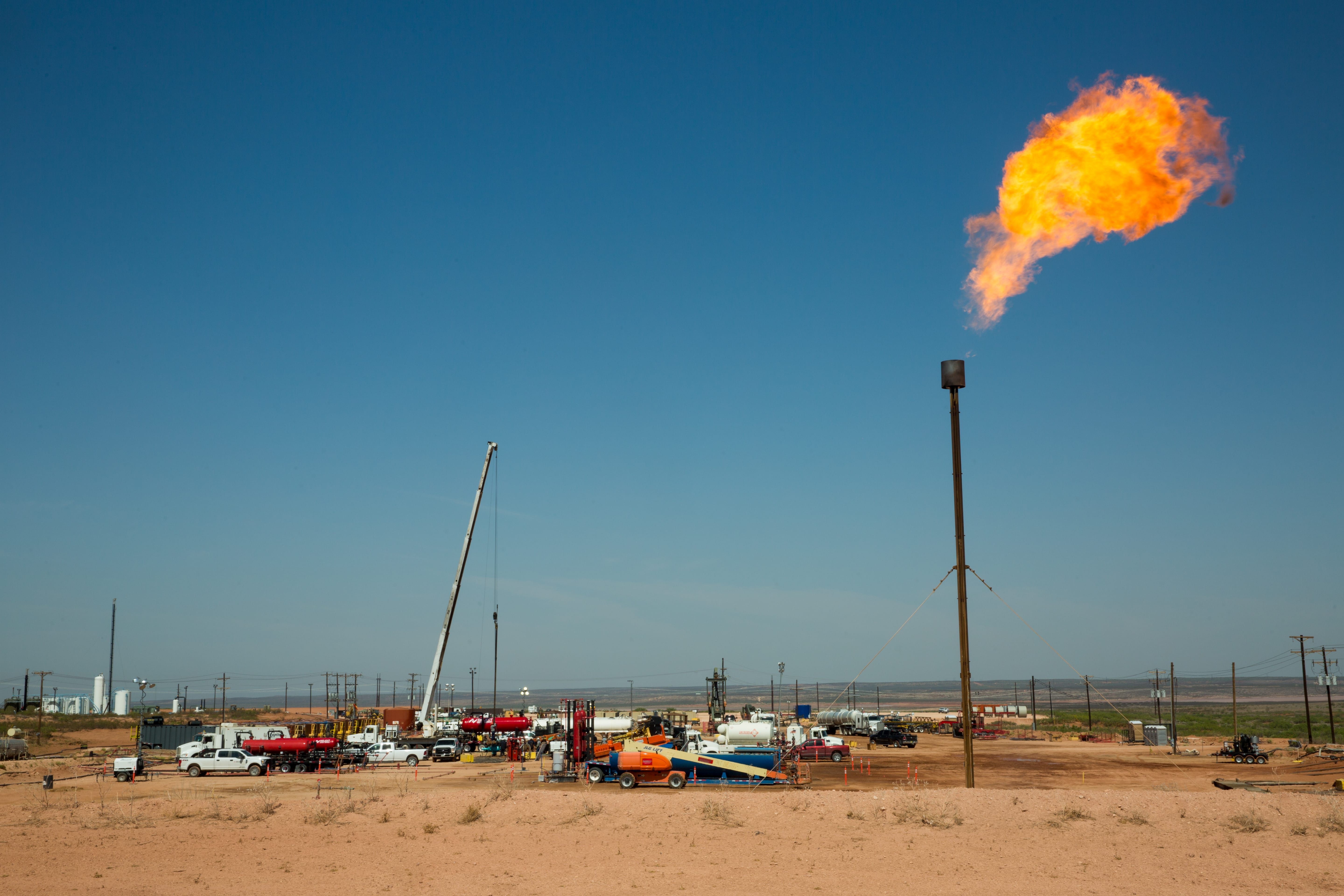 A flare burns atop a drill pad on land near Carlsbad, N.M., that Wayne Smith leased for ranching before his death in October. The development covered seven times more acreage than the Bureau of Land Management said would be used, Smith said in May. (Robin Zielinski for the Center for Public Integrity)
