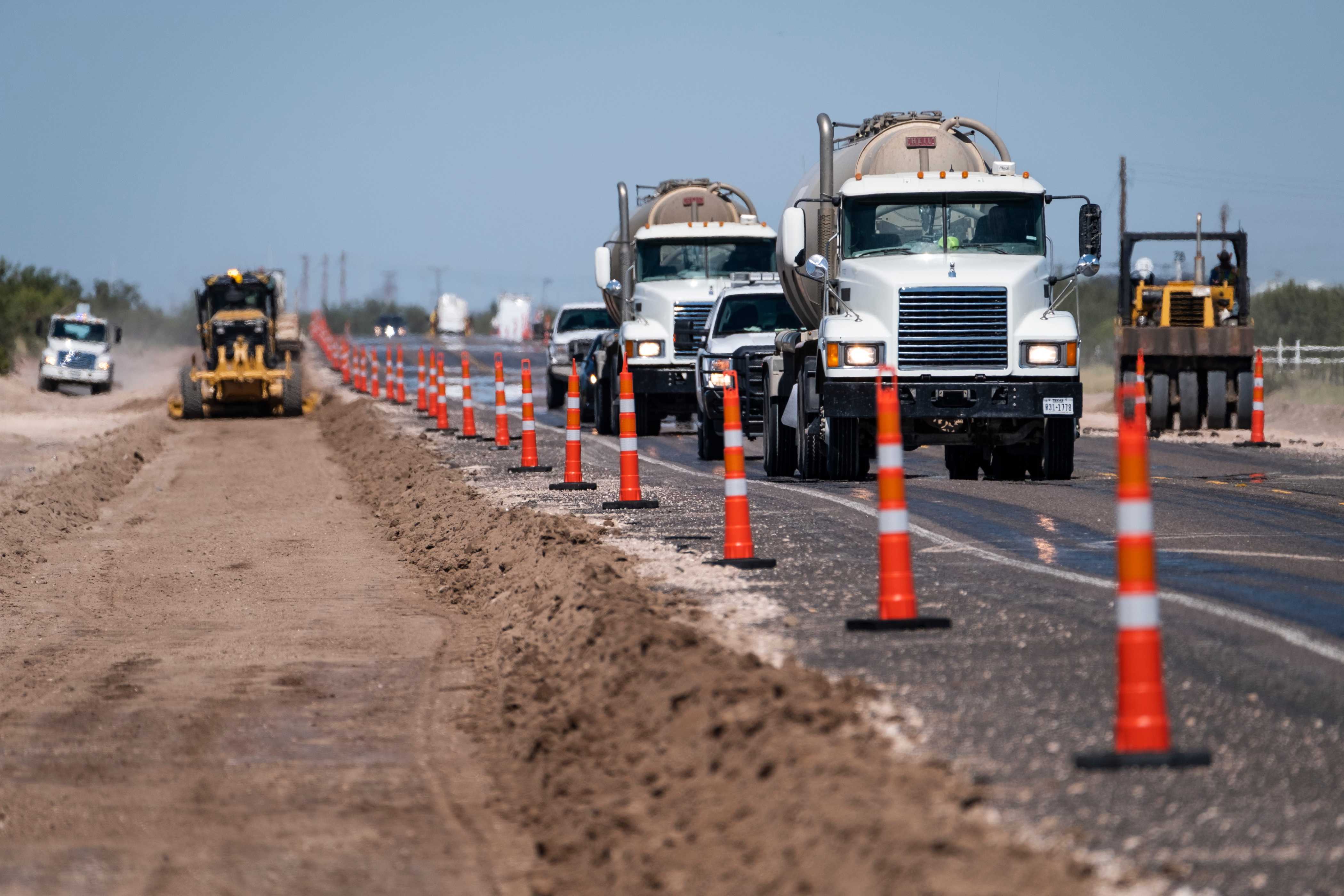 Oilfield traffic moves through a road construction zone on Highway 18 north of Wickett, Texas.